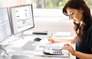 woman using a calculator to charge management fees