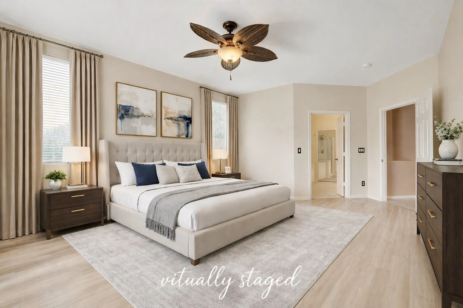 Virtually staged Green Valley Ranch primary bedroom with neutral paint, blonde flooring and ensuite bathroom access