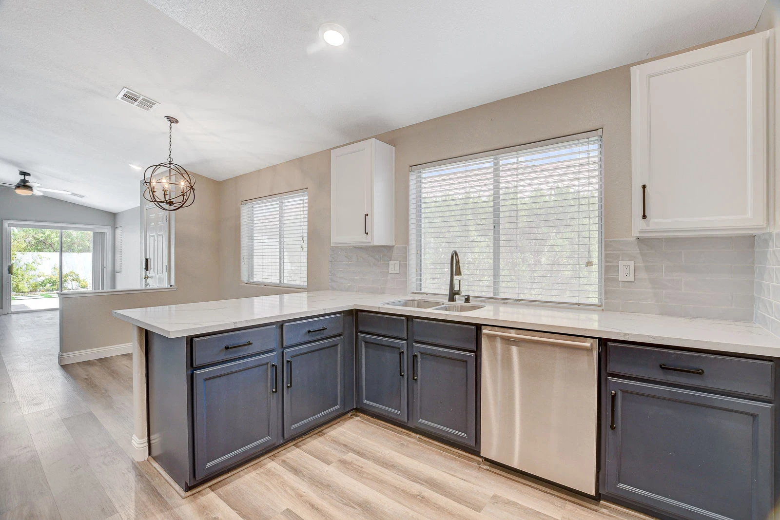 Updated Green Valley Ranch rental kitchen with two-tone cabinets, light counters, stainless steel appliances, and durable flooring