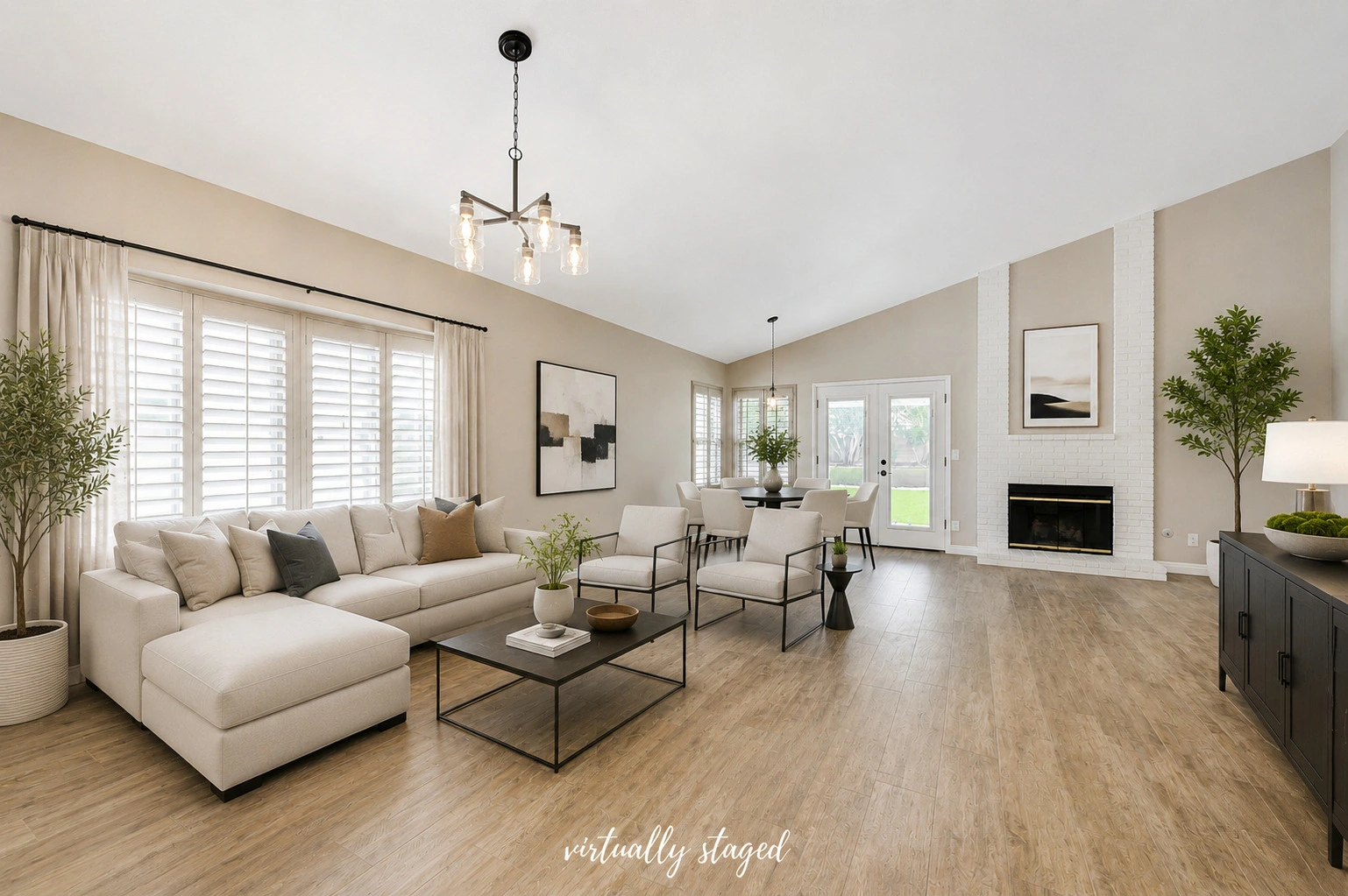 Virtually staged open living room with a vaulted ceiling and fireplace in a Henderson investment property