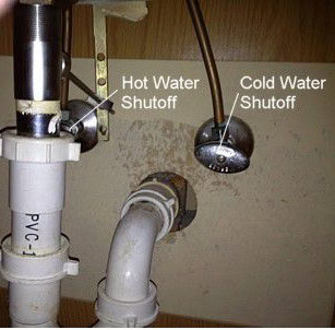 Hot and cold angle-stop shut-off valves below a rental home sink