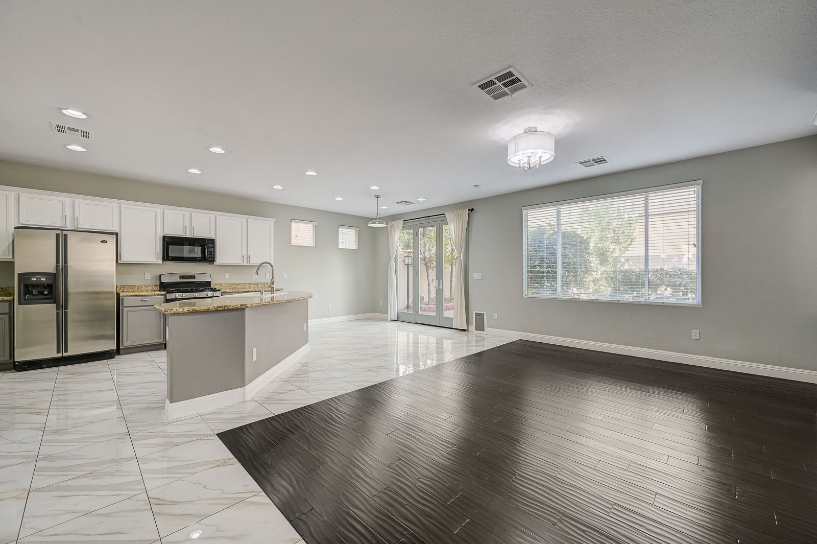 Unfurnished living room and kitchen in an anonymized guard-gated Summerlin 89135 rental managed by Rice Real Estate & Property Management